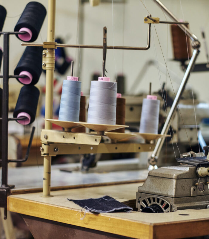 Close-up image of a lot of coils with a threads at the sewing workshop.